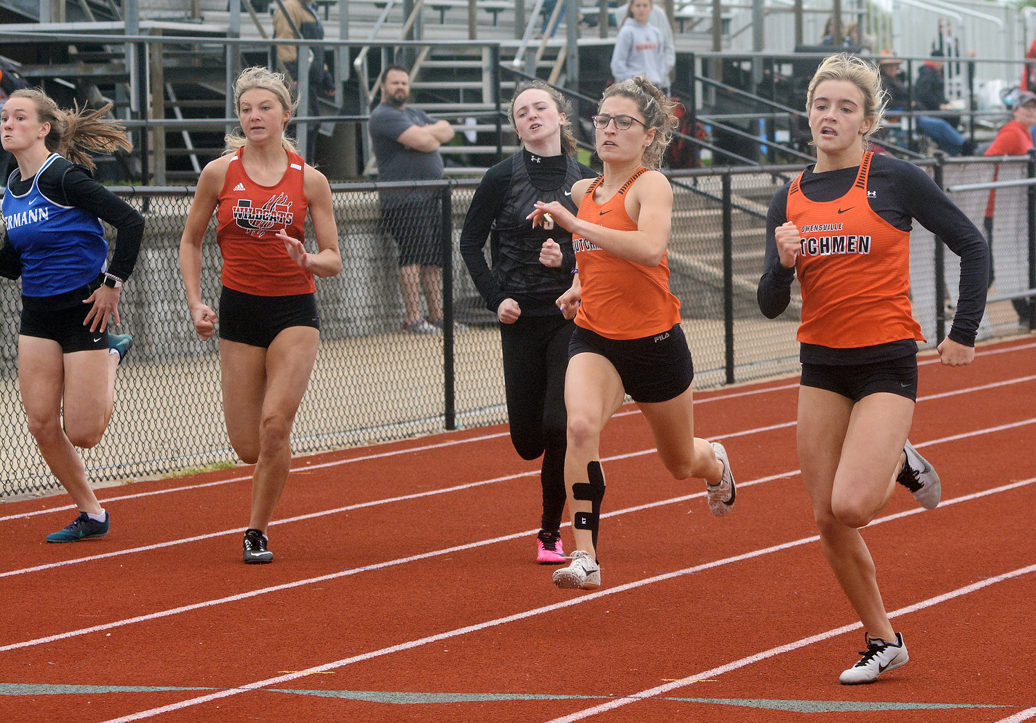 Saylor Richardson and Emma Daniels (far right) race side by side in the finals of the varsity girls 100-meter dash during Monday’s Four Rivers Conference (FRC) Track Meet at Owensville High School’s Dutchmen Field under rainy weather conditions. Daniels won the race with Richardson placing second giving the Dutchgirls a quick 18 team points early in the meet.